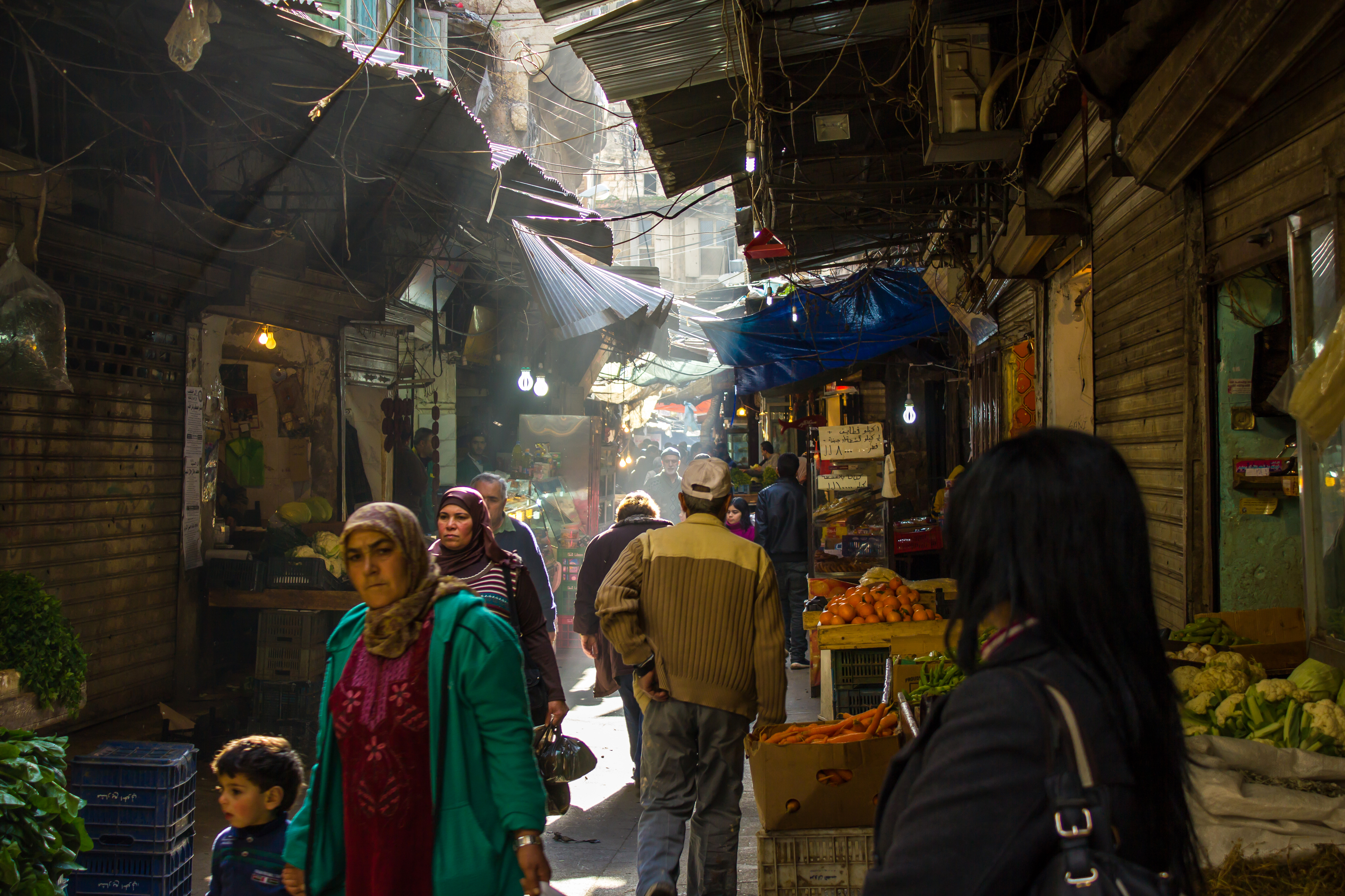 Souk in Tripoli. Photo credit: kateafter, https://www.istockphoto.com/photo/people-walk-through-the-narrow-alley-of-a-covered-souk-in-tripoli-lebanon-gm1150501933-311461976 Featured image
