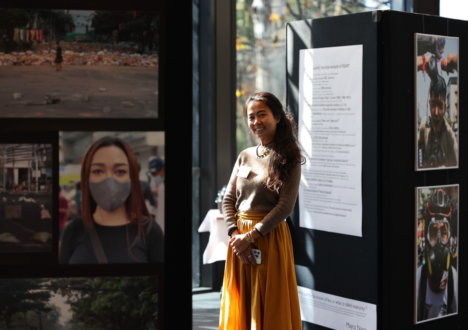 Photographer Mayco Naing at her ANU exhibition, “How to quantify FEAR".